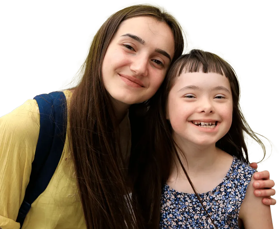 Two girls smiling together, one with her arm around the other