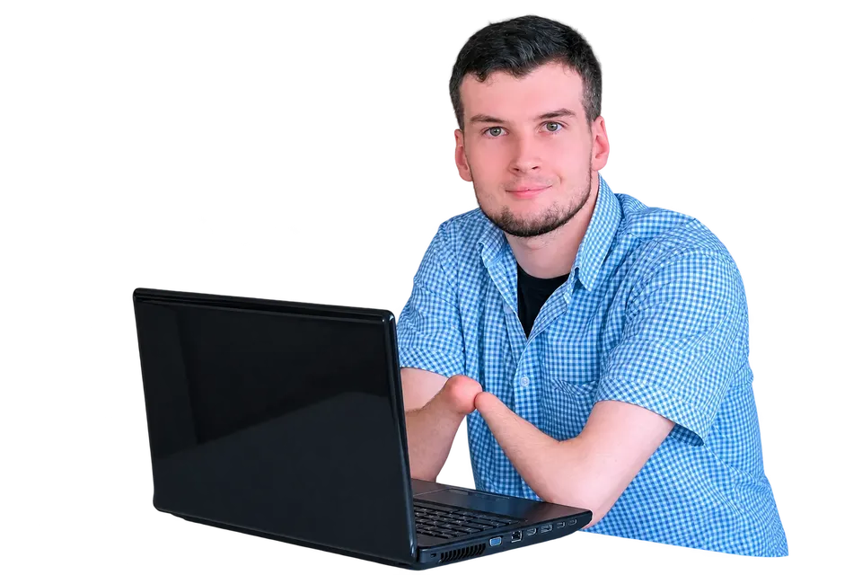 A smiling young man sitting at a laptop