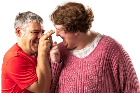 Two people laughing together at home