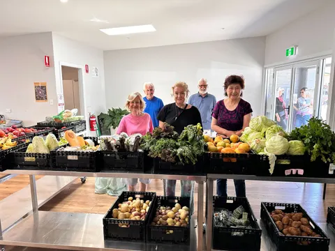 People with crates of free fruit and vegetables inside the hub