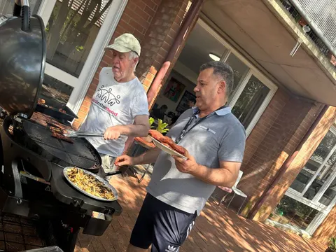 Two men at a community barbecue